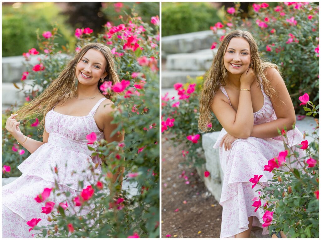 A young woman with curly hair sits among vibrant pink flowers, smiling warmly. She wears a light pink floral dress, creating a cheerful, summery vibe.